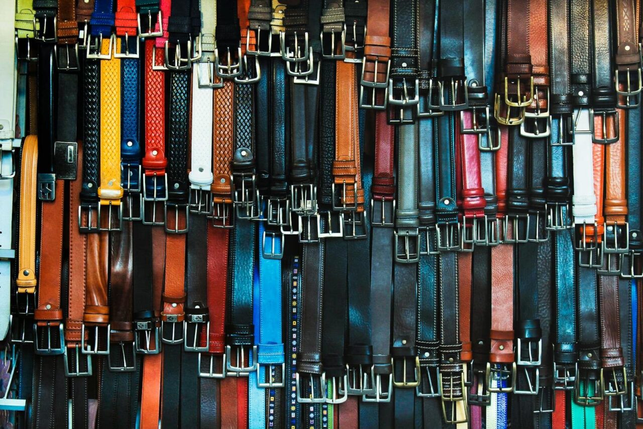 A vibrant assortment of leather belts hanging in a shop in Florence, Italy.