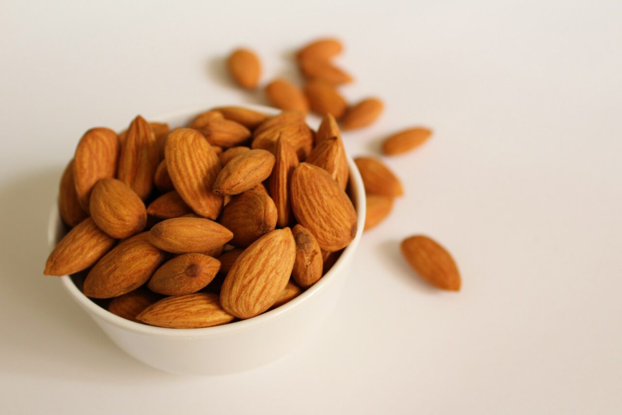 brown almond nuts on white ceramic bowl