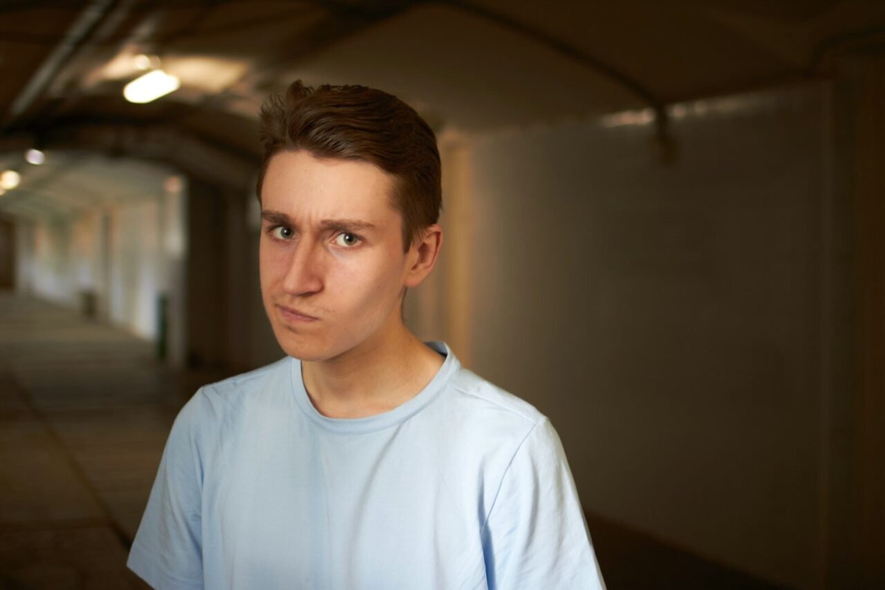 A man looks skeptical in a dark tunnel