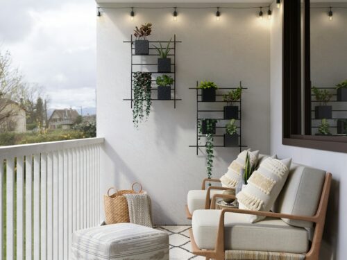 2 brown wooden armchairs beside white wall