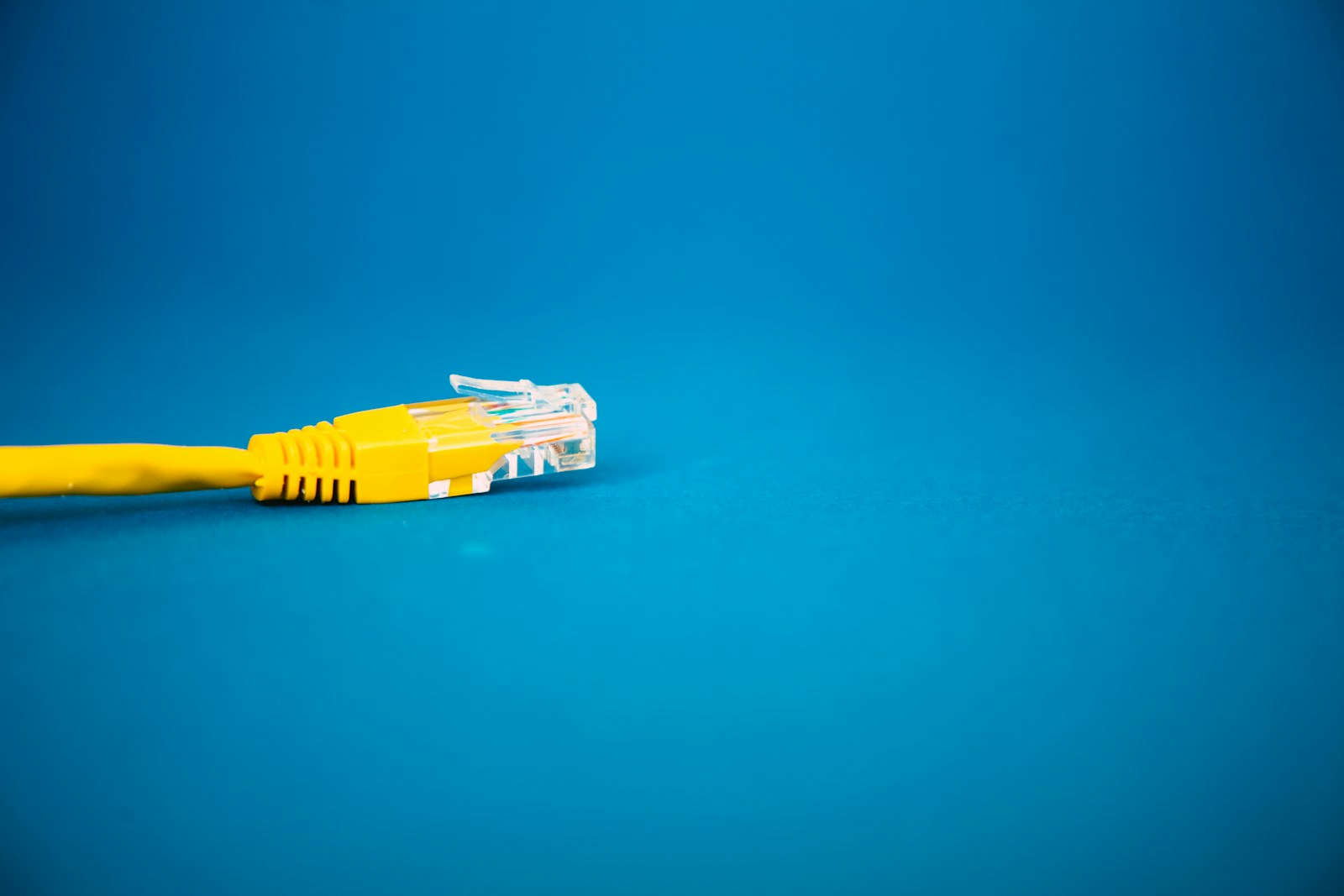 a yellow ethernet cable on a blue background