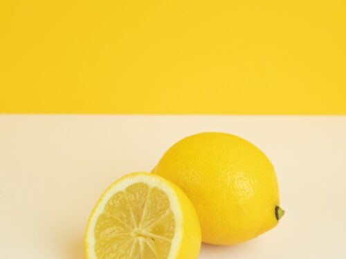 yellow lemon fruit on white surface