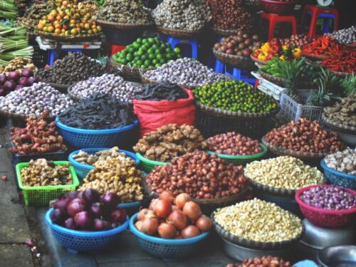 assorted spices on containers at the market