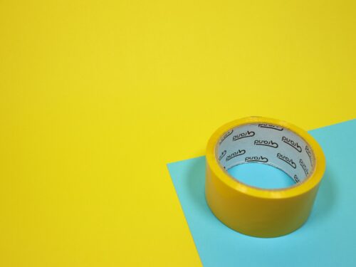 yellow duct tape on blue surface