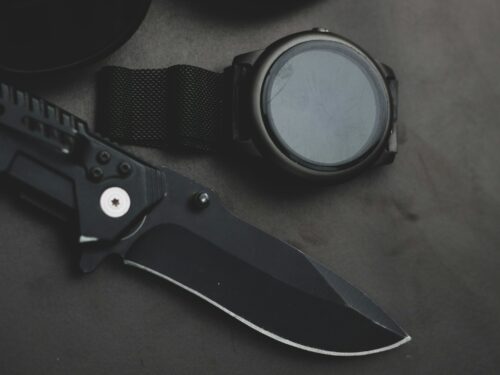 black and silver scissors on brown wooden table