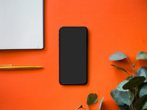 black iphone 5 on orange surface