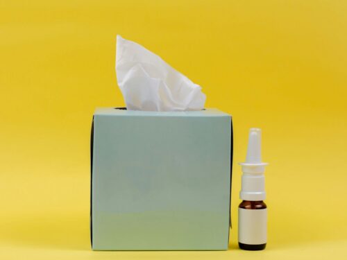 white and brown bottle beside white tissue box