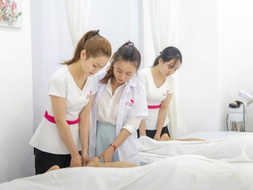 one woman assisting another woman in massaging