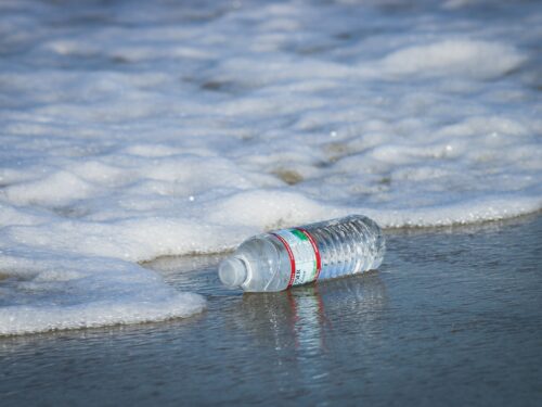 water plastic bottle on seashore