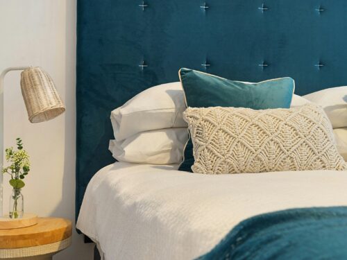 blue bed and mattress with pillows