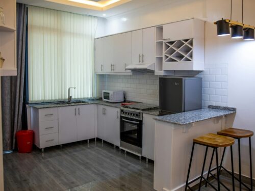 a kitchen with white cabinets