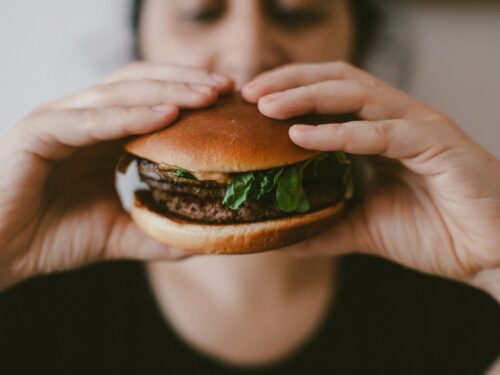 person holding burger