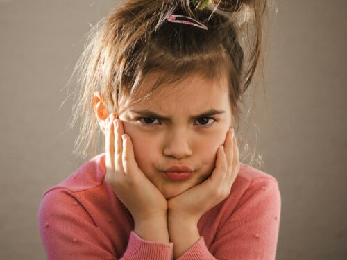 a young girl with her hands on her face