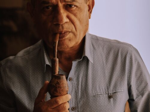 man in gray dress shirt smoking