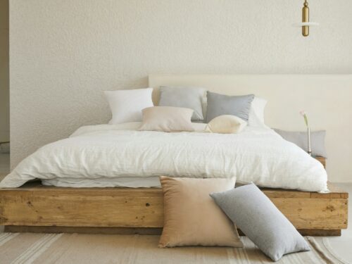 white bed pillow on brown wooden bed frame