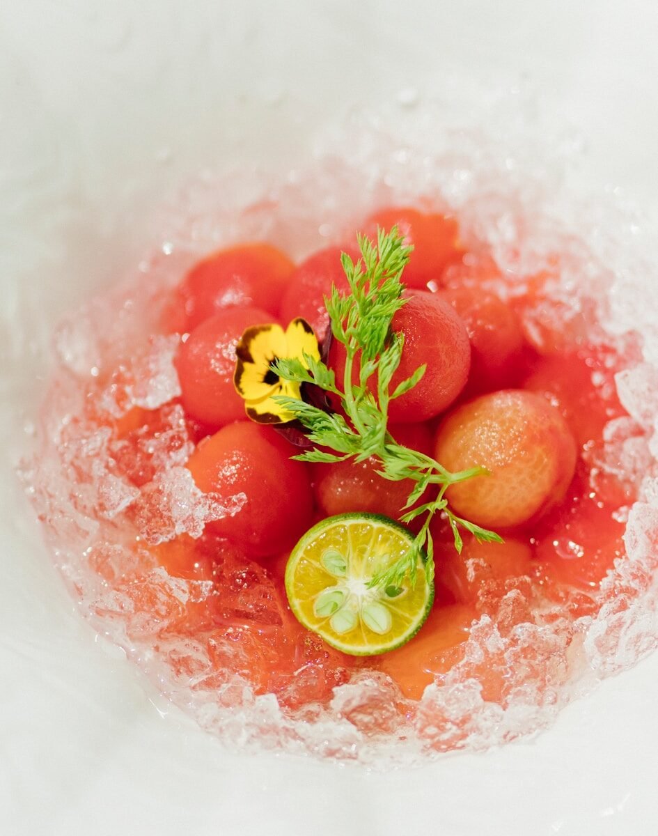 sliced orange fruit on red liquid