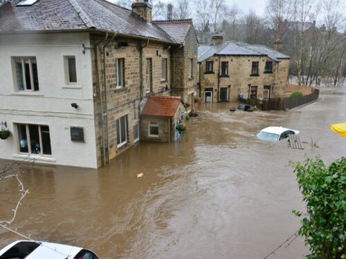 brown and white concrete house beside river during daytime