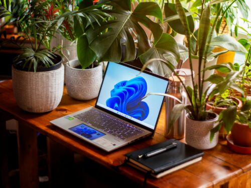 a laptop computer sitting on top of a wooden table