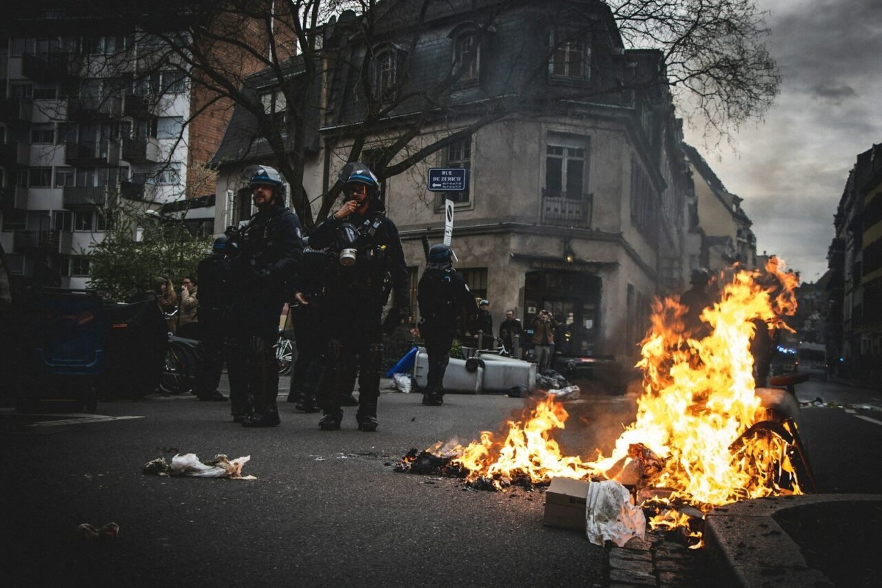 a group of police standing around a fire