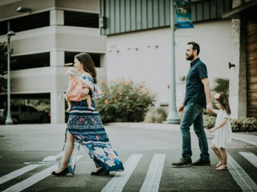 man and woman crossing road