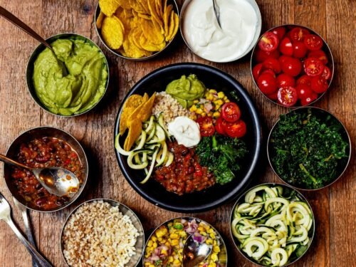 sliced vegetables and fruits on black ceramic plate