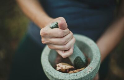 person grinding on mortar and pestle