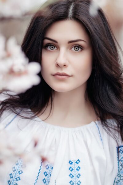 woman standing near white petaled flower