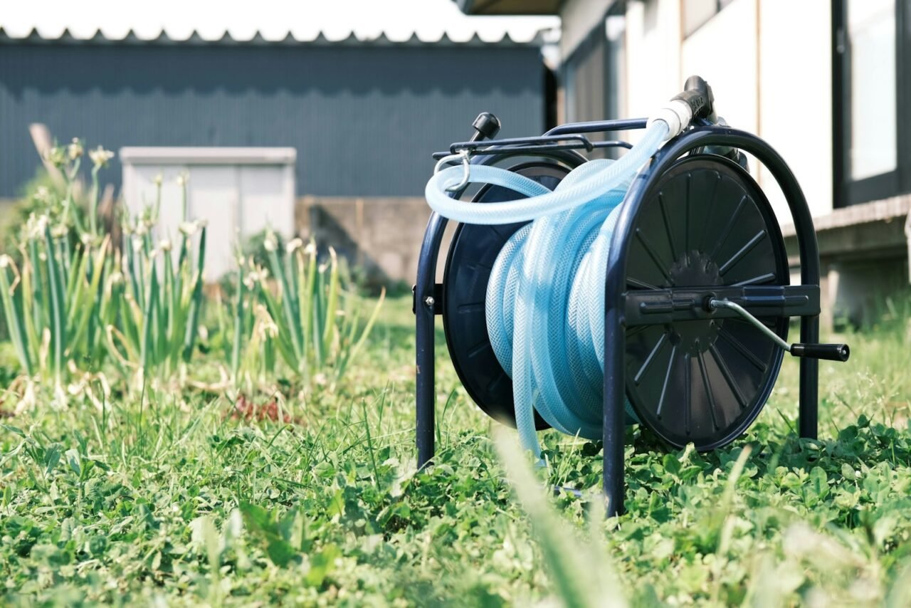 a spool of blue hose sitting on top of a reel