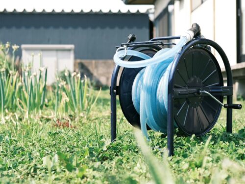 a spool of blue hose sitting on top of a reel