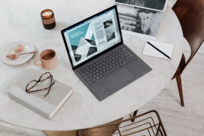 black laptop computer on round table on a Surface Laptop