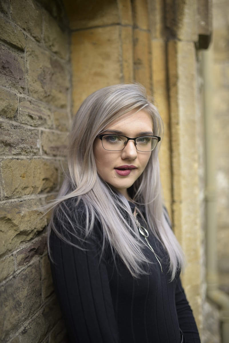 woman in black blazer wearing black framed eyeglasses