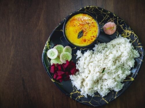 A black plate topped with different types of food