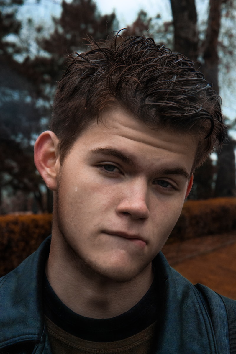 man in black collared shirt