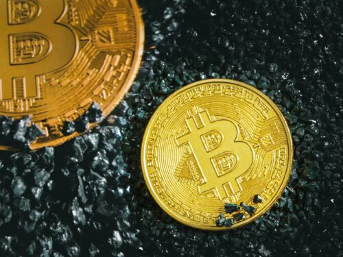 a bitcoin sitting next to a bitcoin on the ground