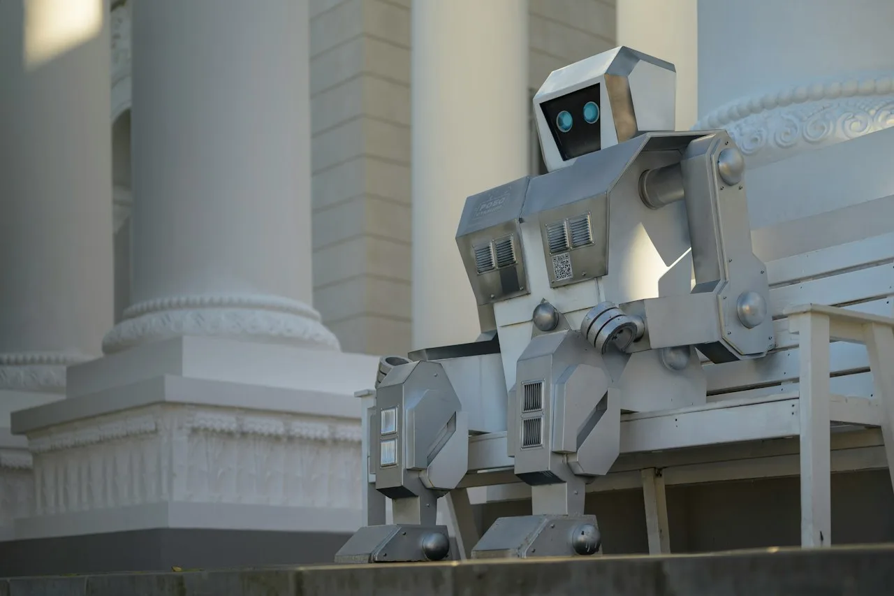 A silver robot sitting on a white bench in front of classical columns