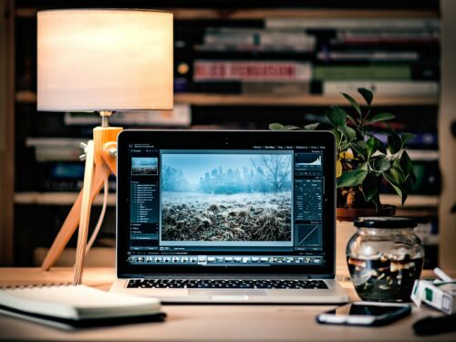 MacBook Pro on brown wooden table inside room