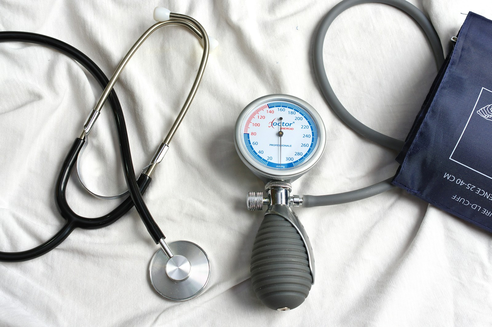 a stethoscope laying on top of a bed next to a medical bag