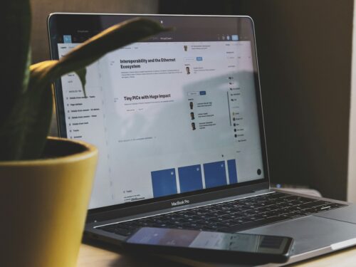 black and silver laptop computer beside yellow ceramic mug