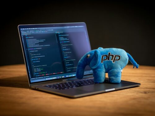 blue elephant plush toy on black laptop computer