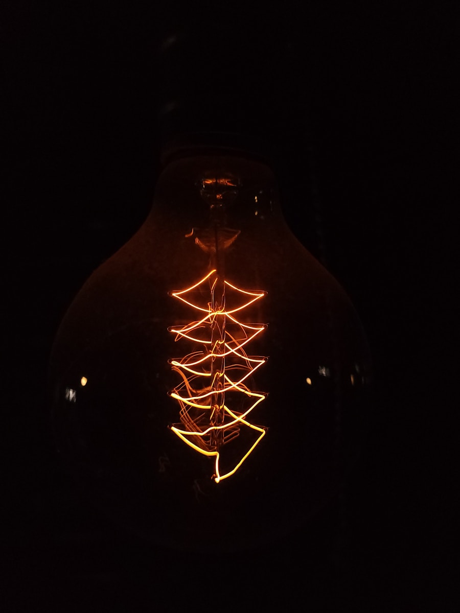 a lit up light bulb in the dark