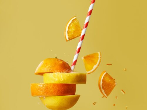 sliced orange fruit with straw