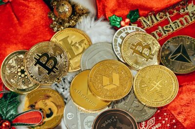 a pile of gold and silver coins sitting on top of a red blanket