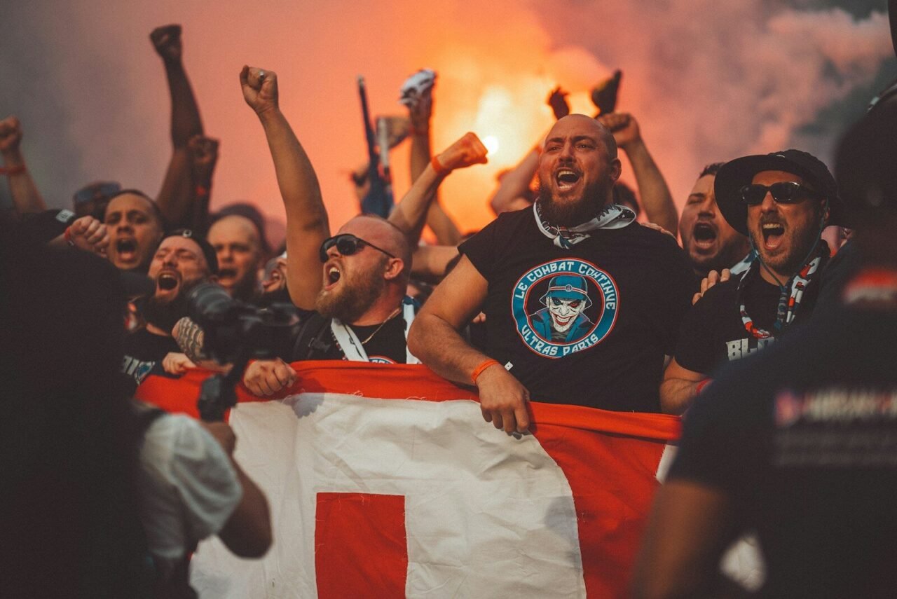 a group of people holding a flag and cheering