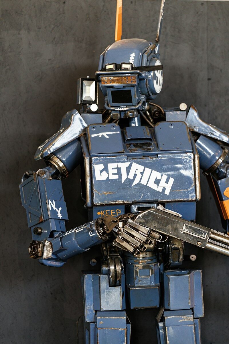 A blue robot with a gun and "get rich" text