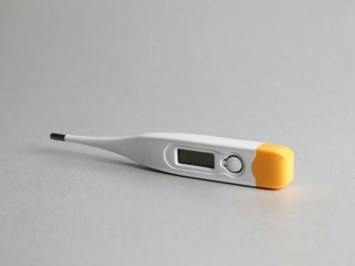 white and yellow thermometer on white surface