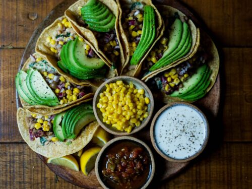 assorted tacos on wooden plate