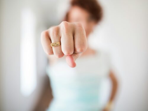 woman showing gold-colored ring