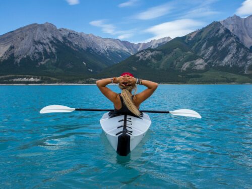 woman riding kayak at the middle of the sea