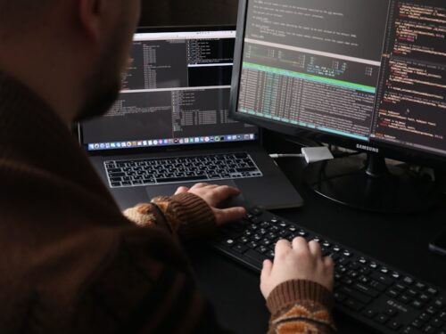 a man sitting in front of a computer on a desk