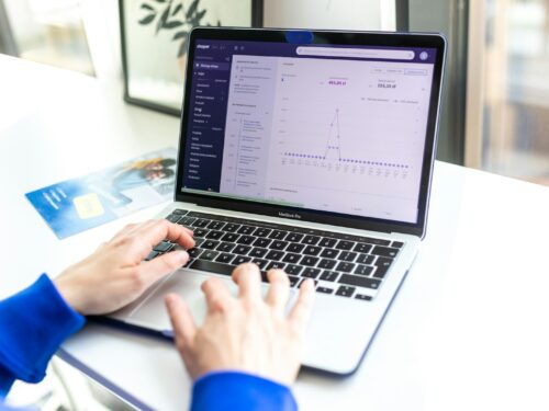 a person typing on a laptop computer on a desk